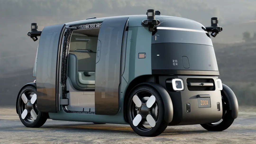 Modern electric vehicle driving autonomously on an urban street — representing the commercial deployment of steering-wheel-free robotaxis following Zoox's first US federal approval for paid driverless ride-hailing service