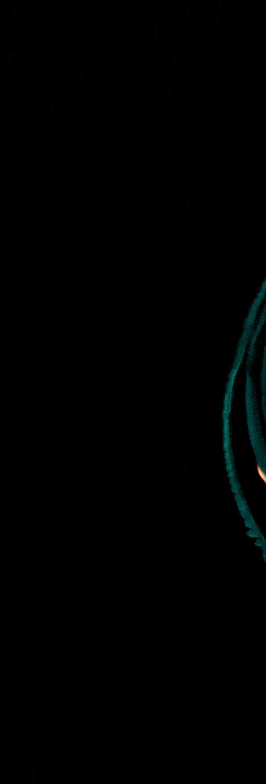 An infinity sign drawn in cyan and white light against a black background