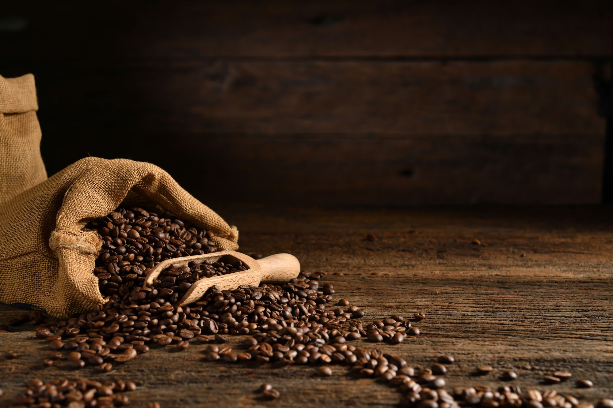 Roasted coffee beans spilling from a burlap sack &mdash; the physical market underlying the ICE Coffee C futures contract covered by the SIGMA Service Desk