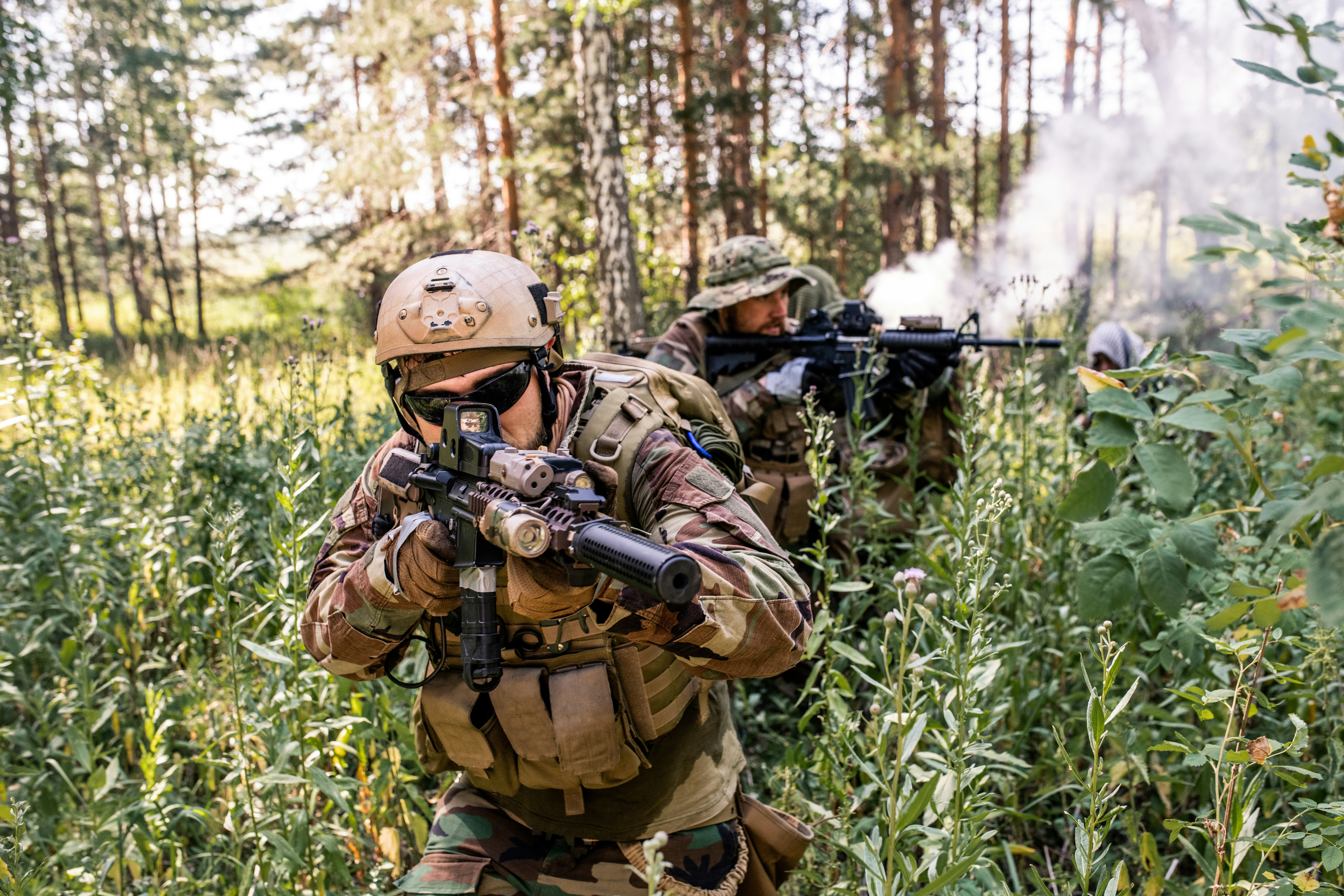 Infantry operators moving through dense forest terrain during a tactical exercise, the operational environment behind the Marine Corps' narrative-tracking procurement