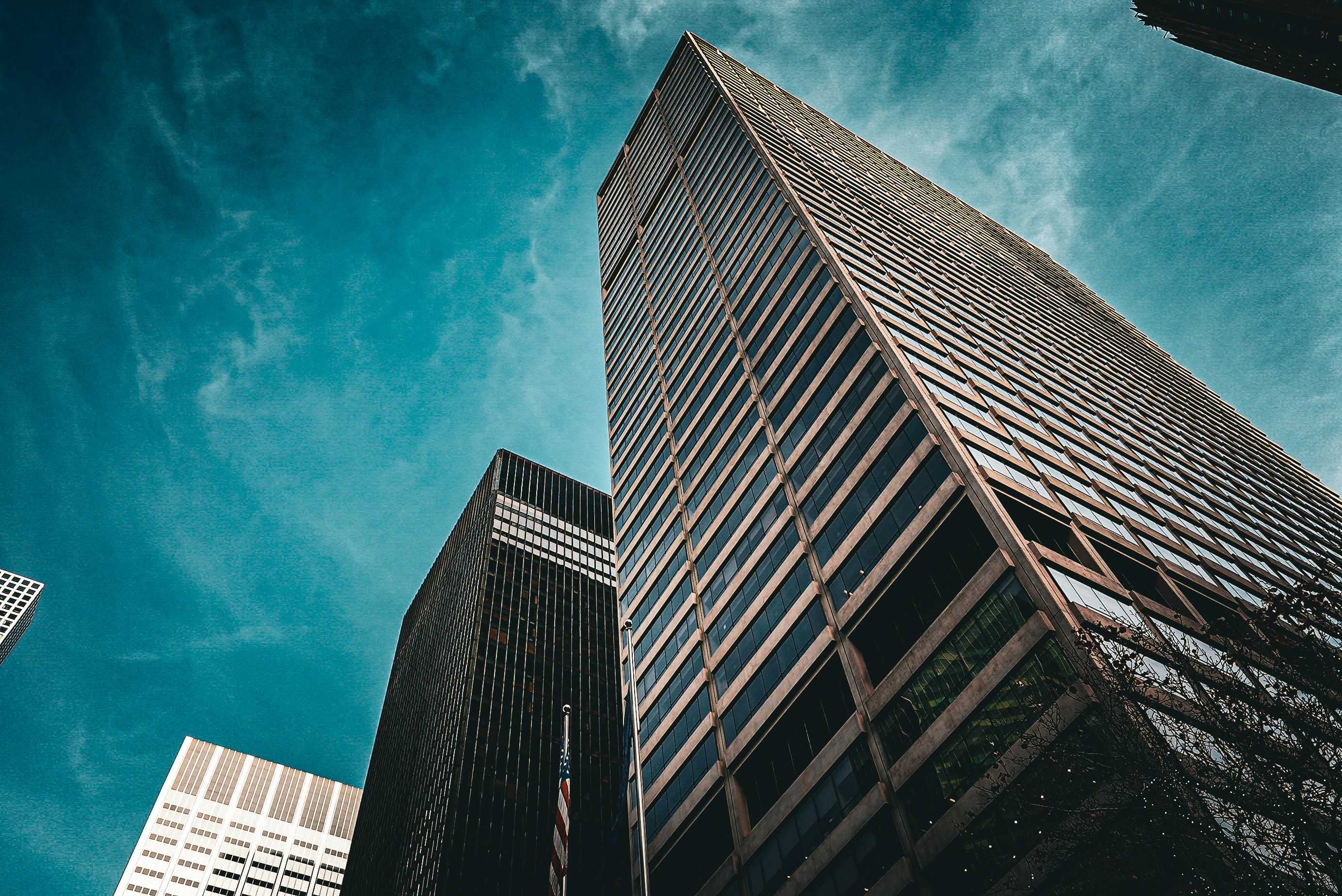 A commercial tower viewed from street level against a clear sky &mdash; the asset class REALIST API returns underwriting output for, on demand