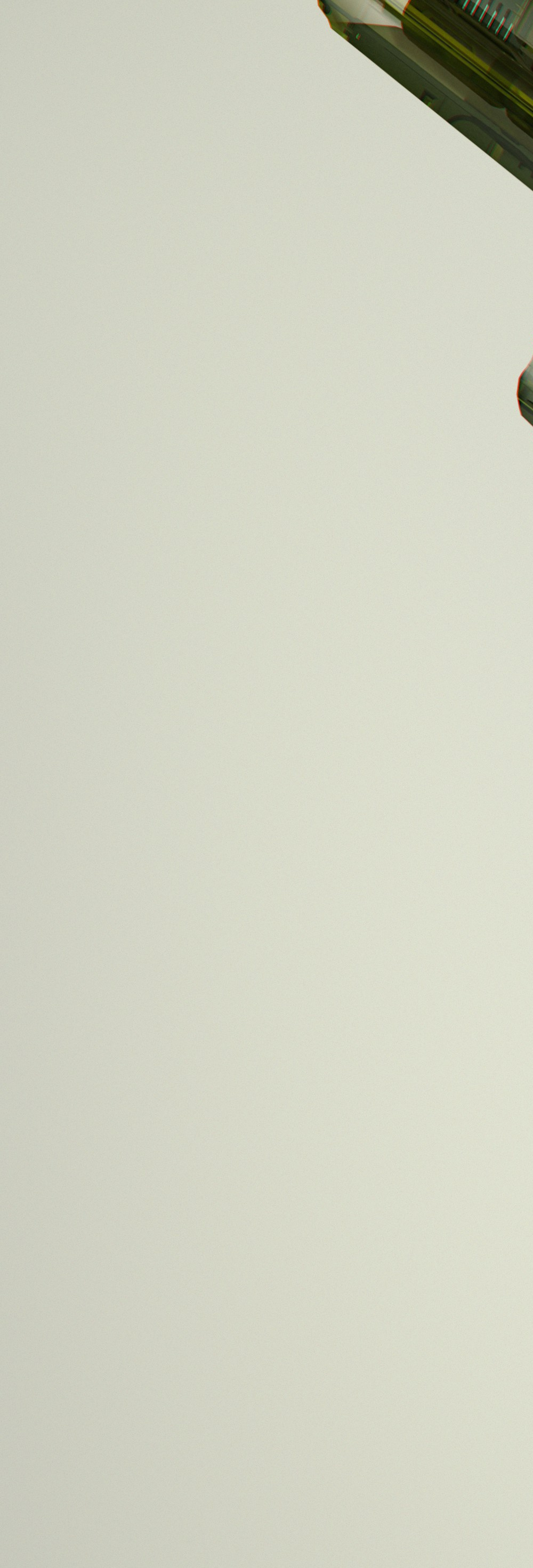 A see-through green handheld radio with its circuitry showing, on a pale grey background